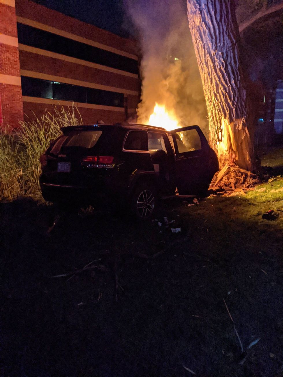 Vehicle on fire after striking tree