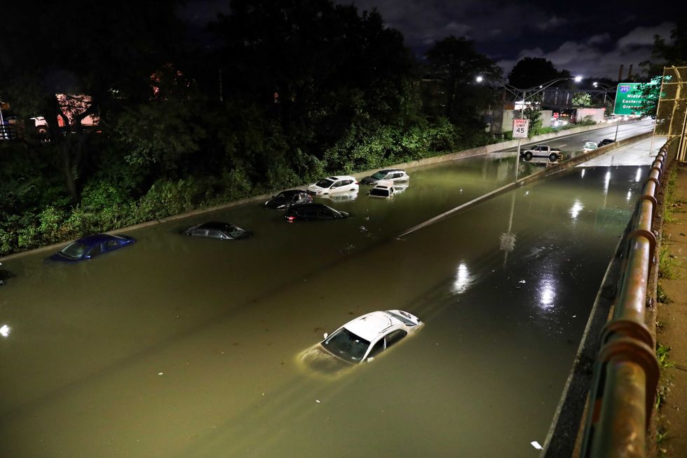 Vehicles are submerged on a waterlogged road in New York, Sept. 2, 2021