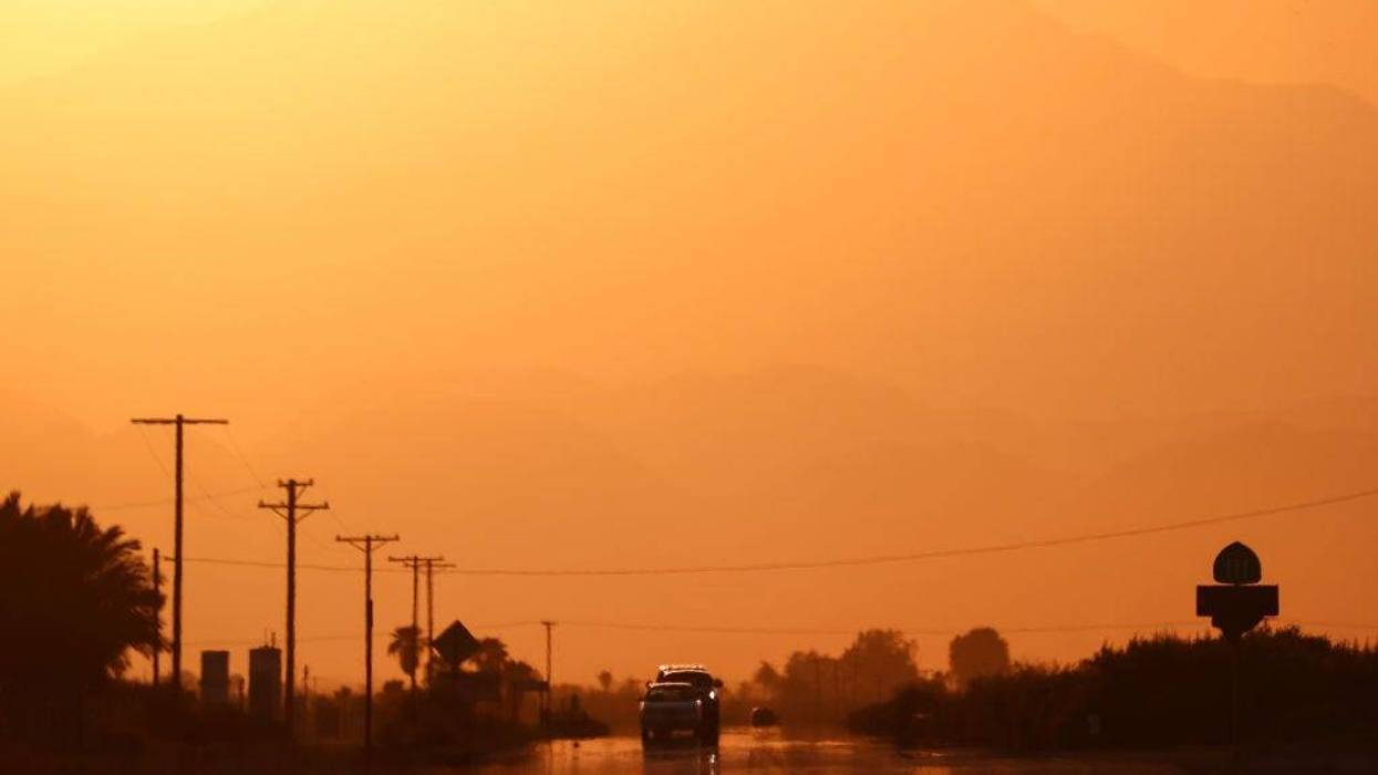 Vehicles are viewed above a 'highway mirage' caused by a thin layer of hot air above the roadway on July 10, 2021 near Thermal, California.