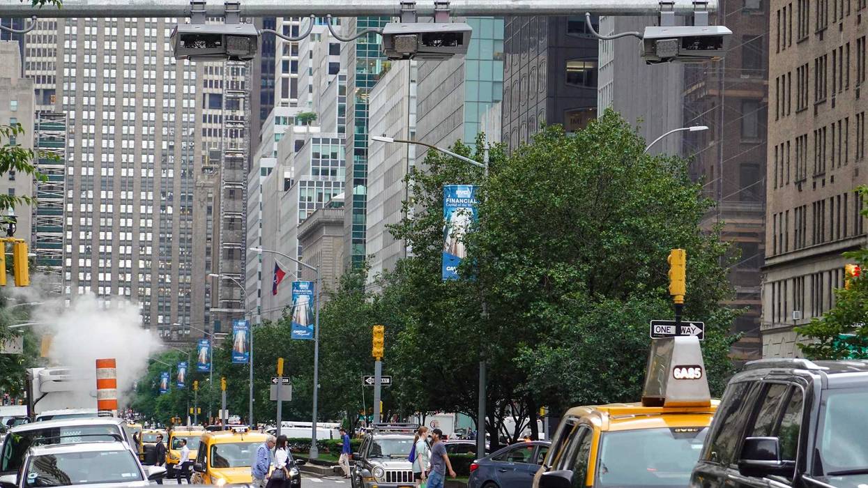 Vehicles drive under the congestion pricing facilities on June 11, 2024