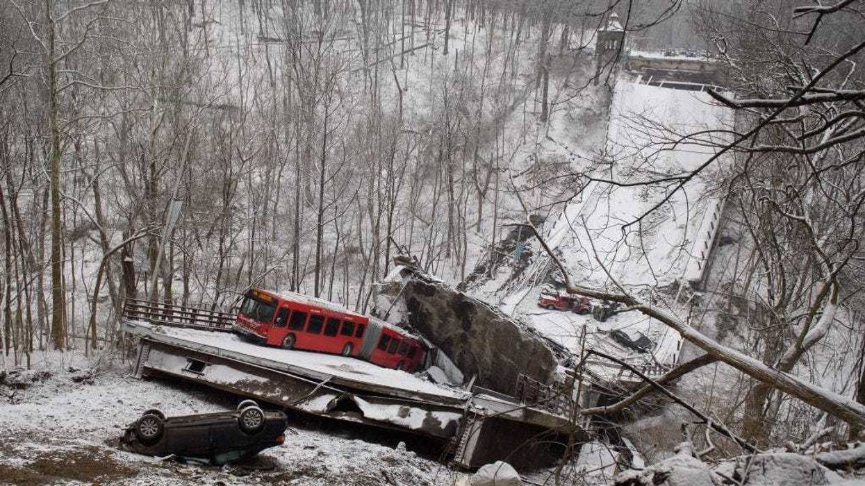 Vehicles including a Port Authority bus are left stranded after a bridge collapsed along Forbes Avenue on January 28, 2022 in Pittsburgh, Pennsylvania.
