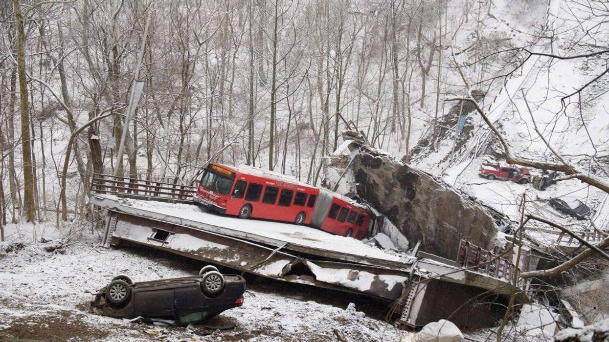 Vehicles including a Port Authority bus are left stranded after a bridge collapsed along Forbes Avenue on January 28, 2022 in Pittsburgh, Pennsylvania