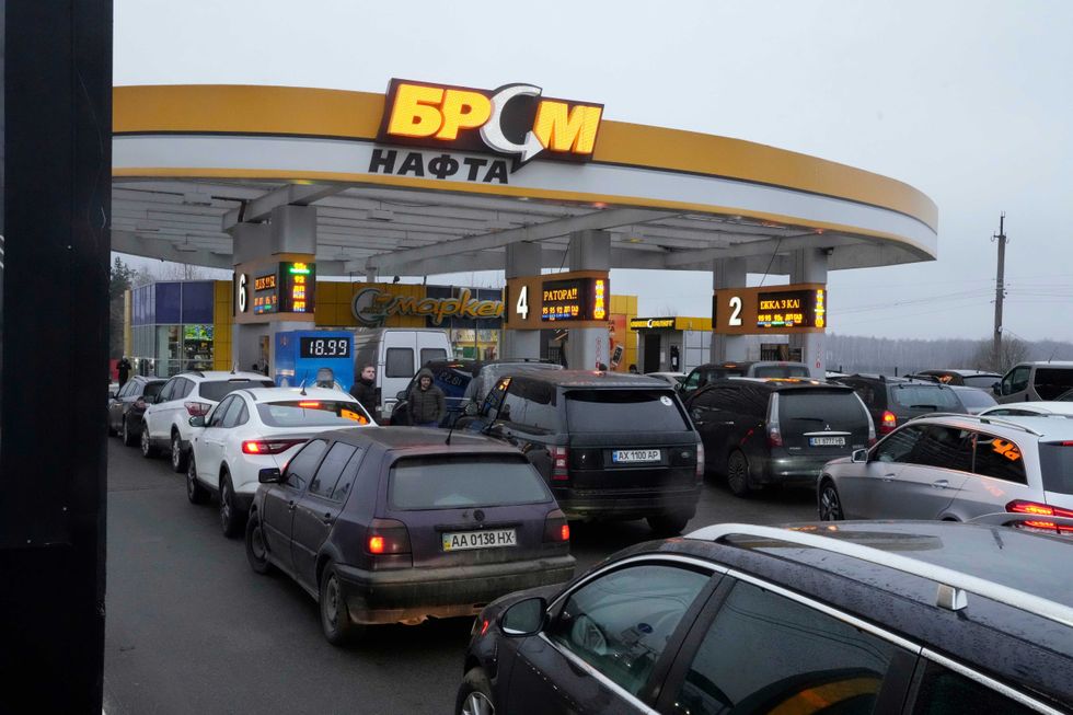 Vehicles line up to a gasoline station in Kyiv, Ukraine, Thursday, Feb. 24, 2022