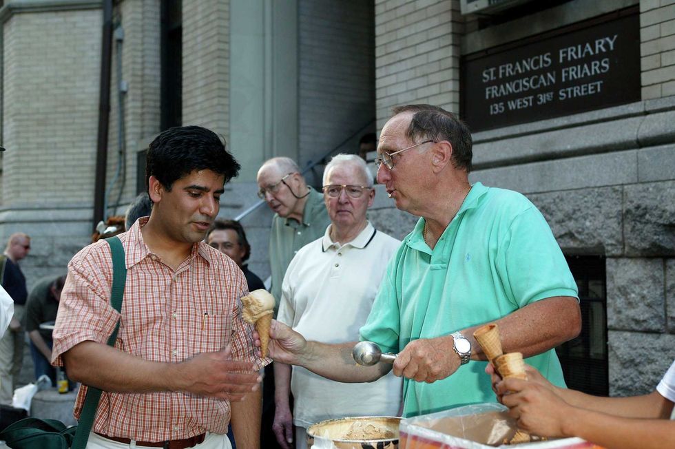 Vendors outside Penn Station scoop out ice cream for stranded commuters.