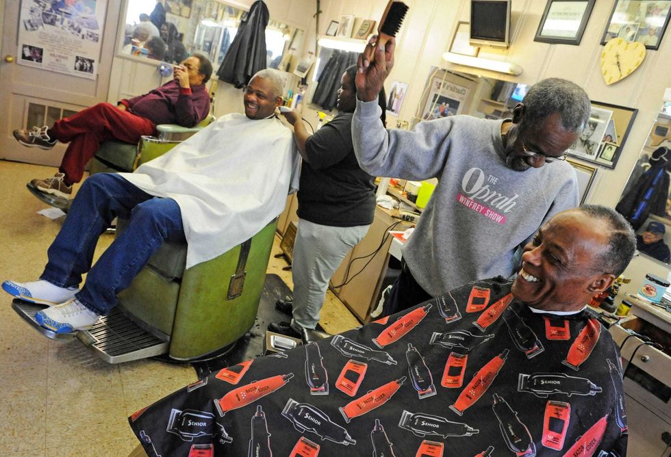 Vernon Winfrey, second from the right, cuts hair on Roland Jones at a barbershop, that is owned by Vernon who is the father of Oprah Winfrey, in Nashville, Tennessee on January 16, 2008.