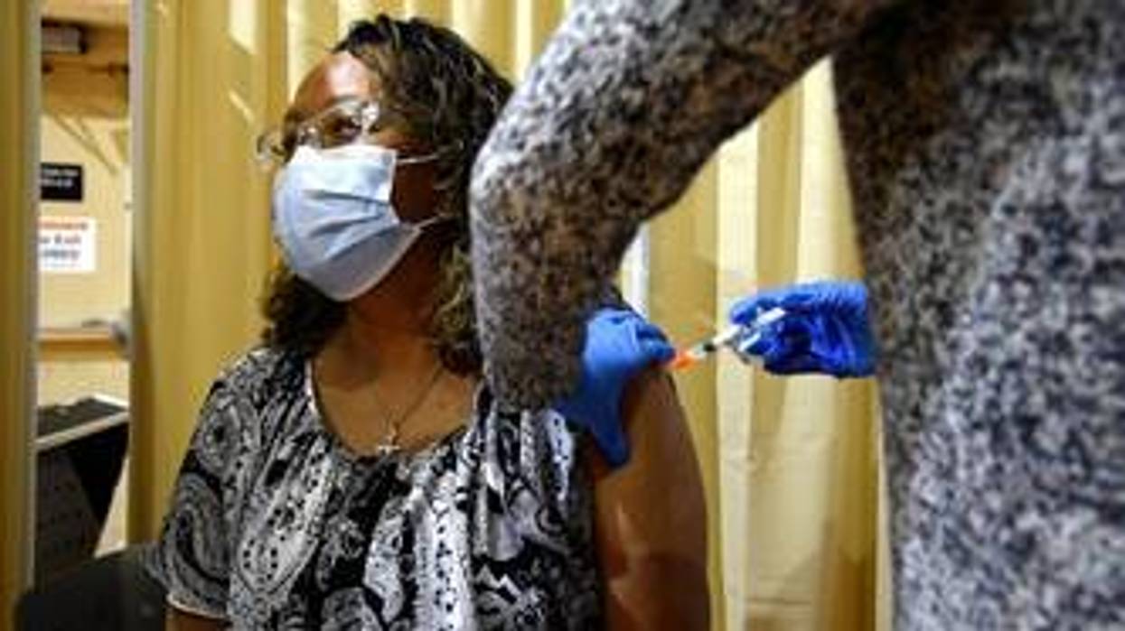 Veteran Pranee McFadgen, who is also an employee of the Cincinnati VA Medical Center’s Community Living Center receives a vaccine at the Cincinnati Veterans Affairs Medical Center as an employee.
