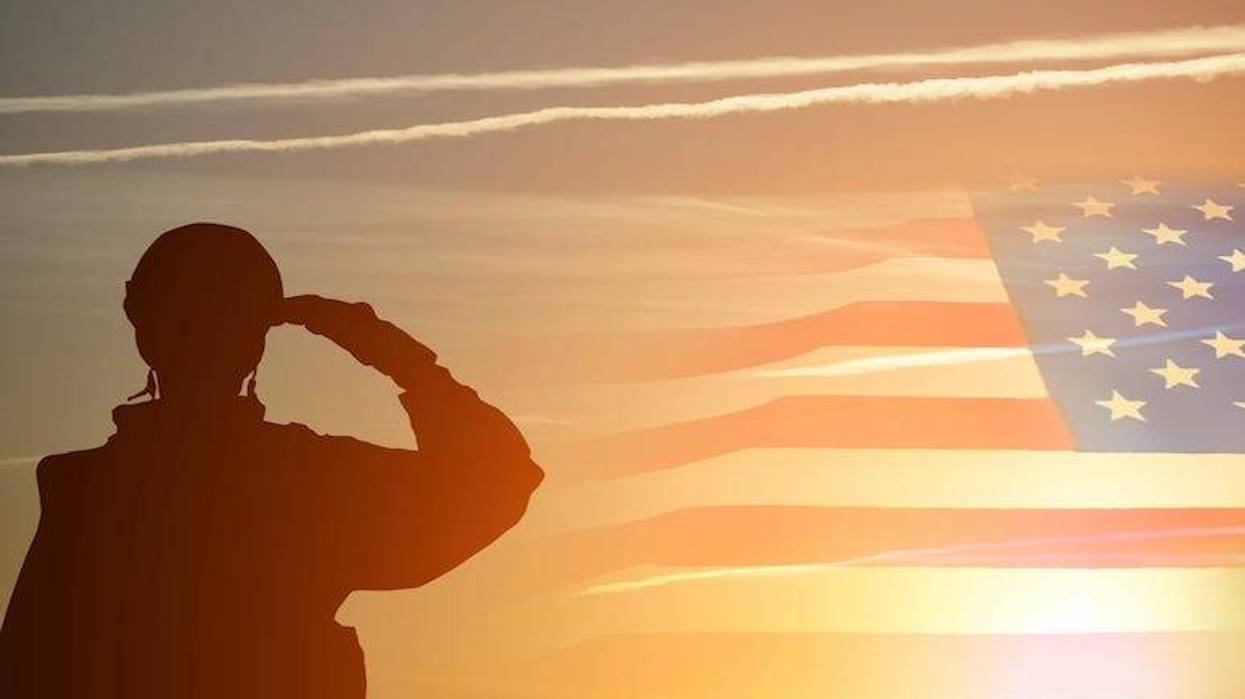 Veteran saluting the flag in sunset