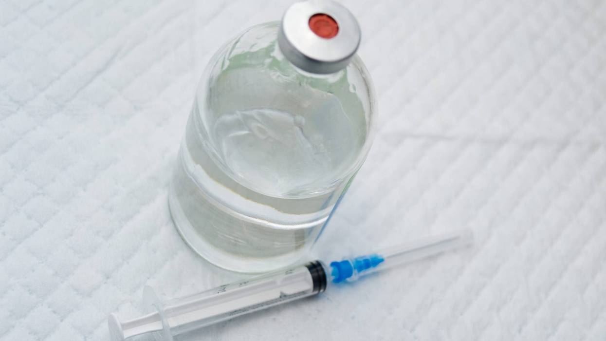 vial with clear drug solution and a syringe