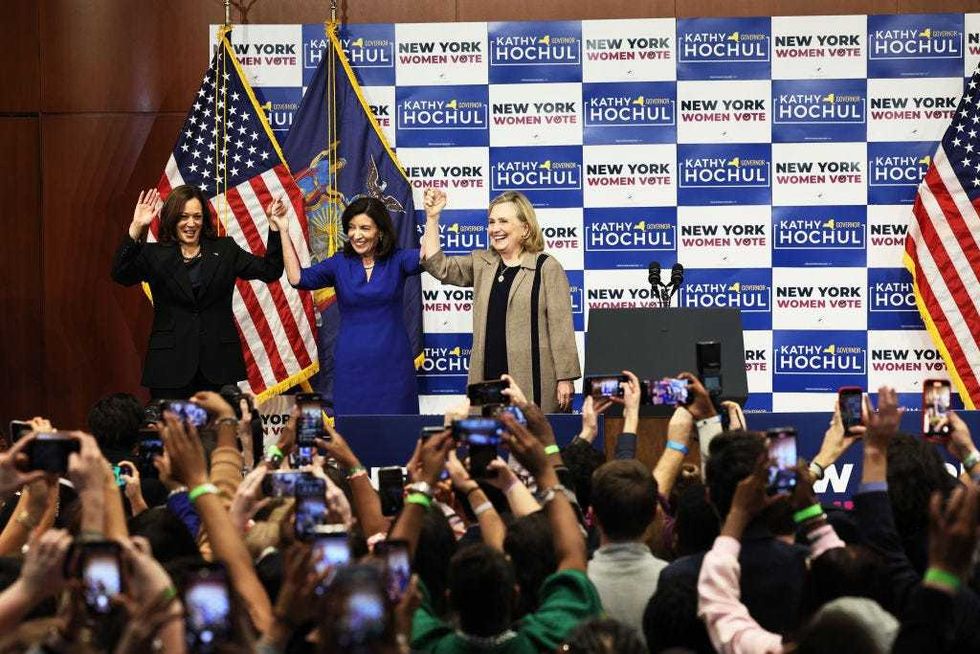 Vice President Kamala Harris, Gov. Kathy Hochul and Secretary Hillary Rodham Clinton hold up their hands at the conclusion of a New York Women "Get Out The Vote" rally at Barnard College on November 03, 2022 in New York City.