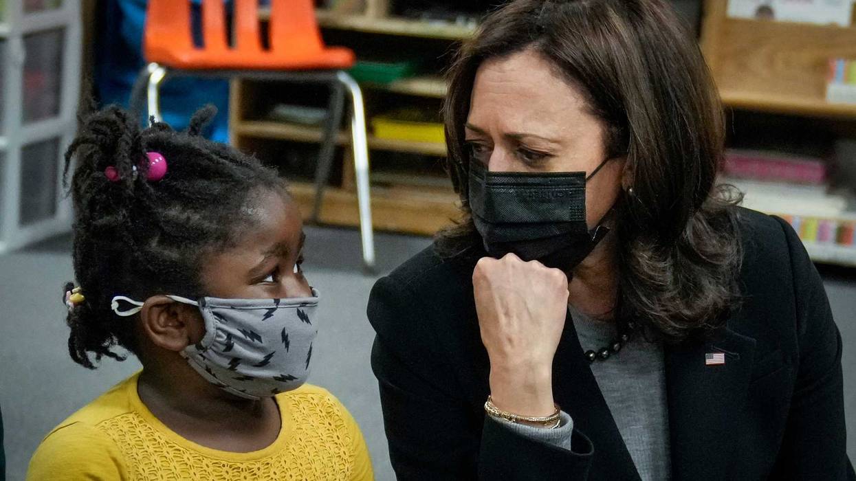 Vice President Kamala Harris sitting on the floor, chatting with a preschool student at West Haven Child Development Center, 3/26/21