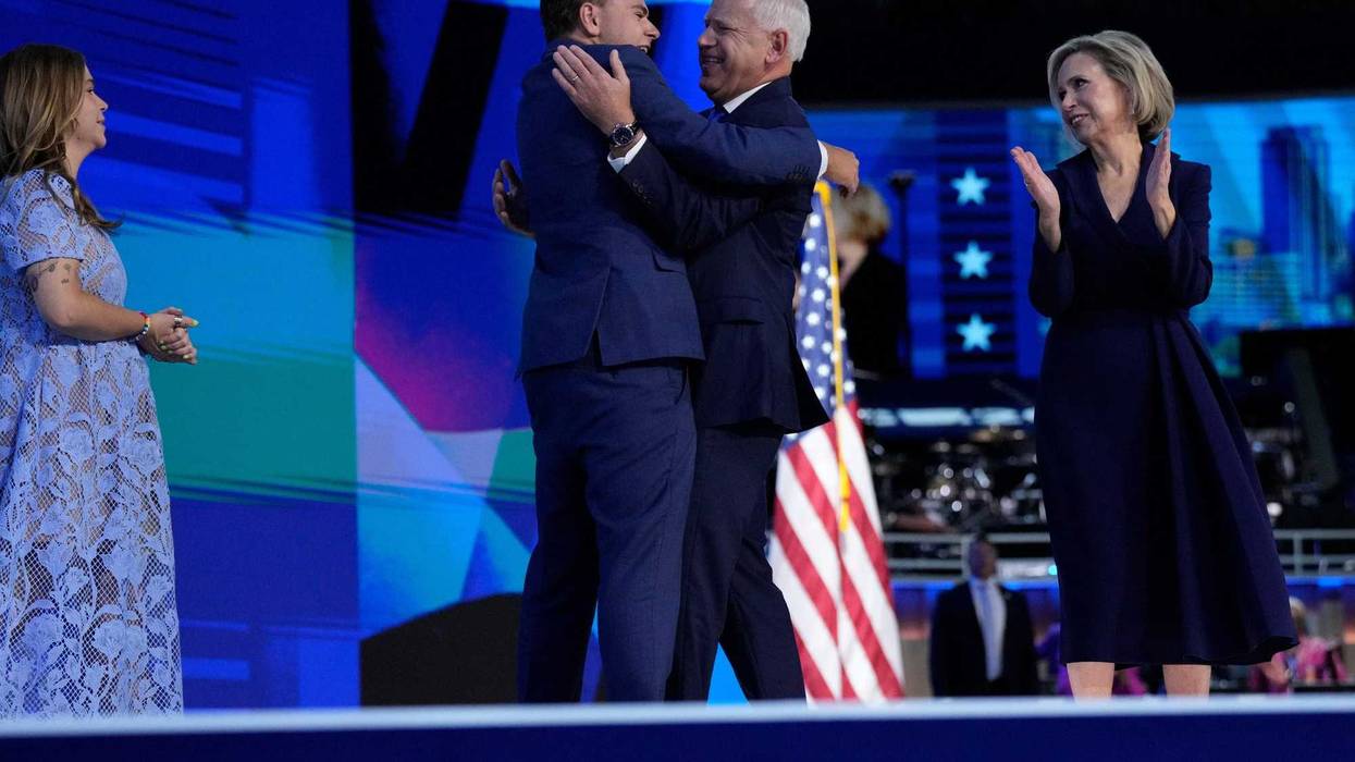 Vice Presidential nominee Tim Walz hugs son Gus Walz during the third day of the Democratic National Convention at the United Center. Hope Walz is at left, Gwen Walz at right.