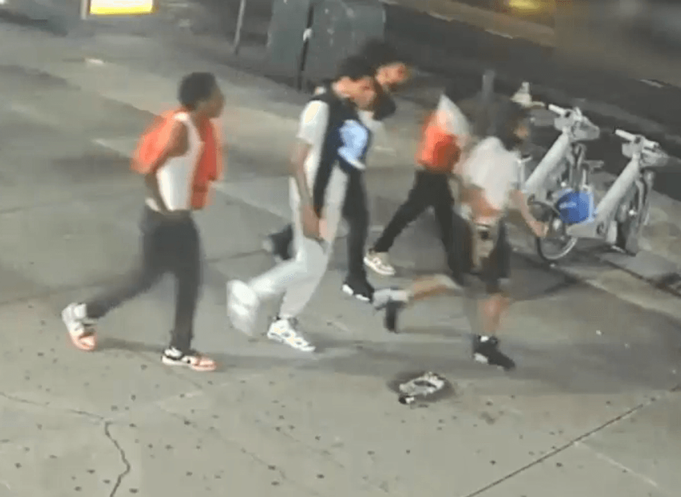 Video released by the NYPD on Wednesday shows the suspects walking down a street around the time of the assault