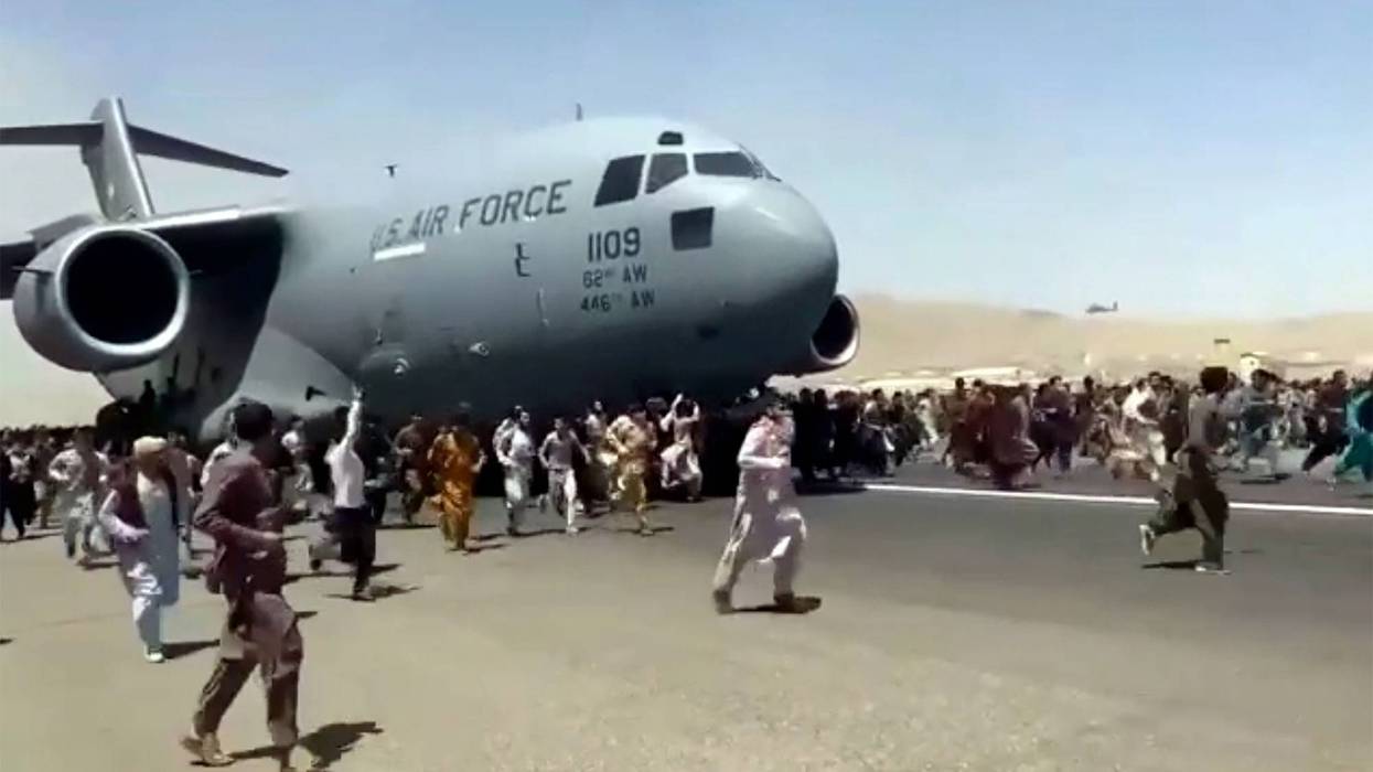 Video shows desperate Afghans climbing US jet to escape