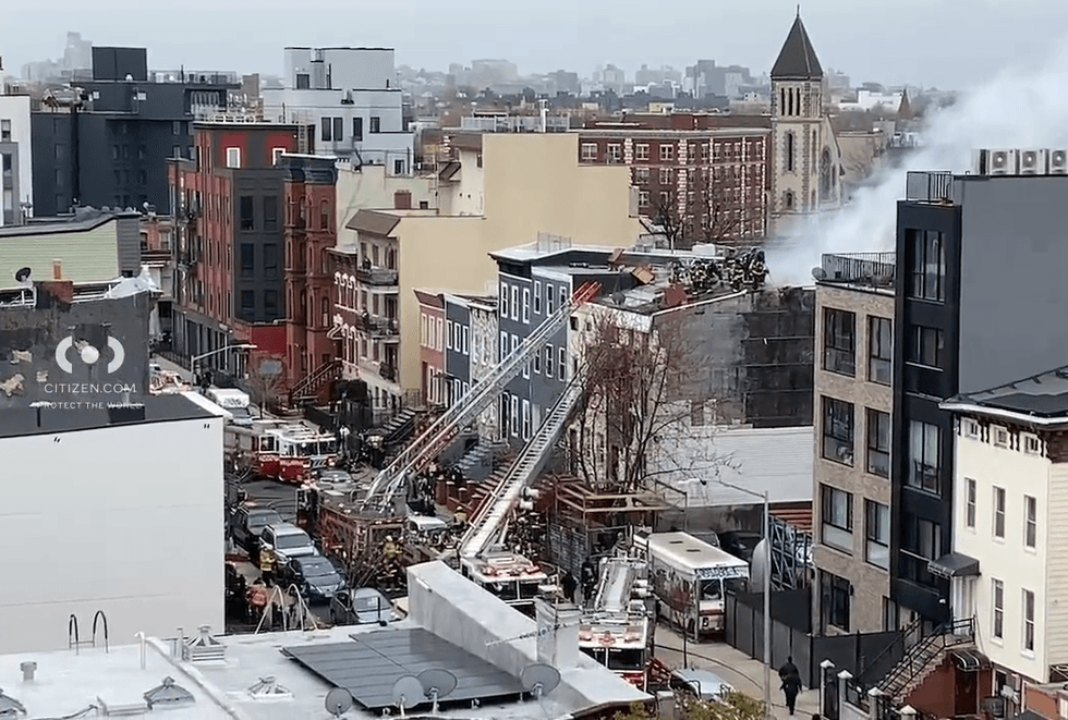 Video shows firefighters on the roof of the four-story residential building