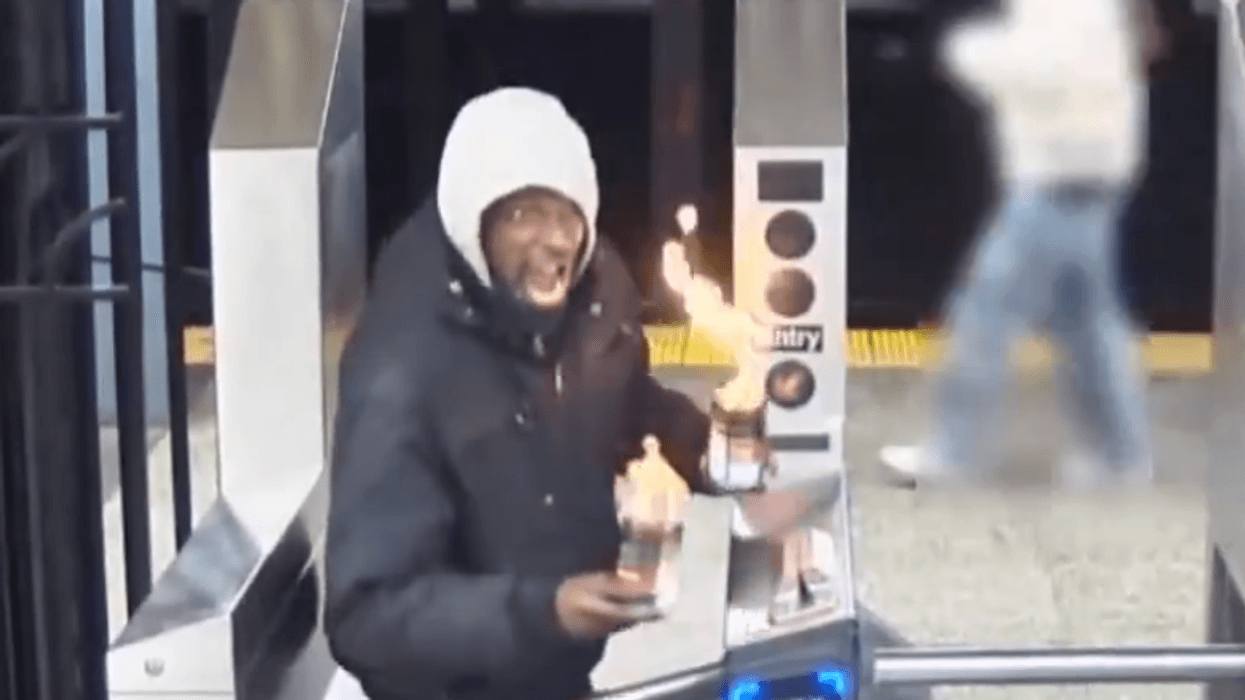 Video shows the suspect holding flaming containers before allegedly hurling one of them at subway riders