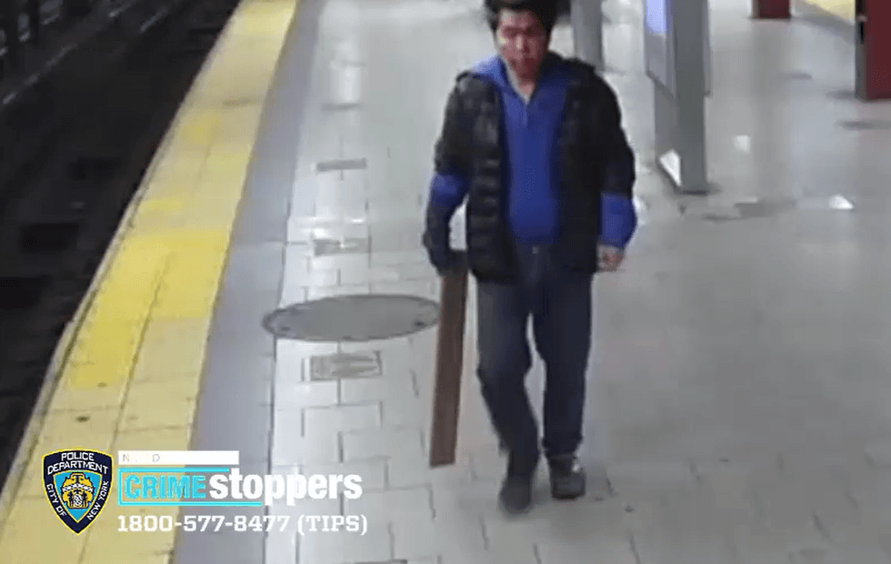 Video shows the suspect holding what appears to be a piece of wood at the subway station around the time of the attack