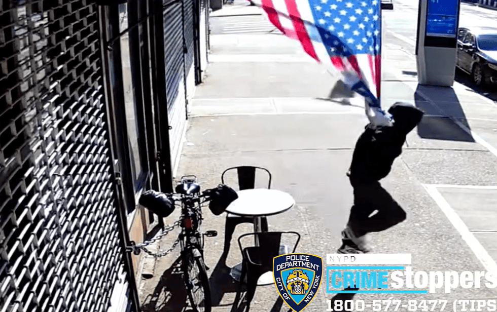 Video shows the suspect ripping down the flag in broad daylight