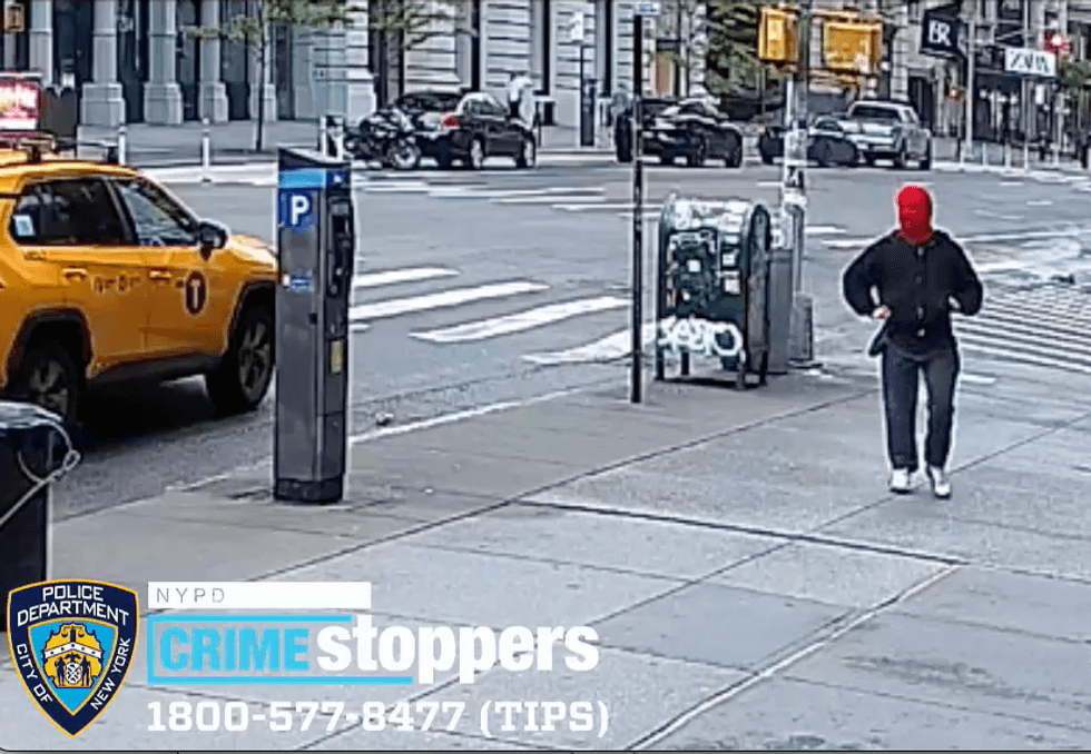 Video shows the suspect walking down the street in a bright red ski mask
