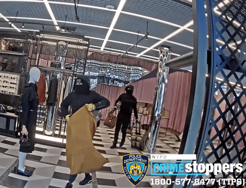 Video shows two masked men hauling items out of the store in the middle of the day