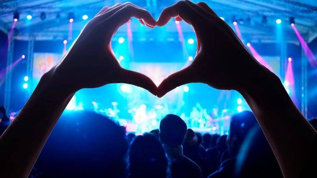 view of concert with hands making a heart shape