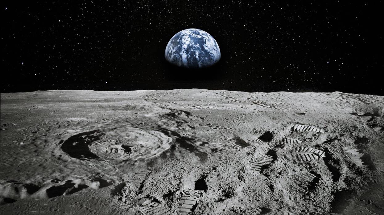 View of the moon with Earth rising on the horizon.