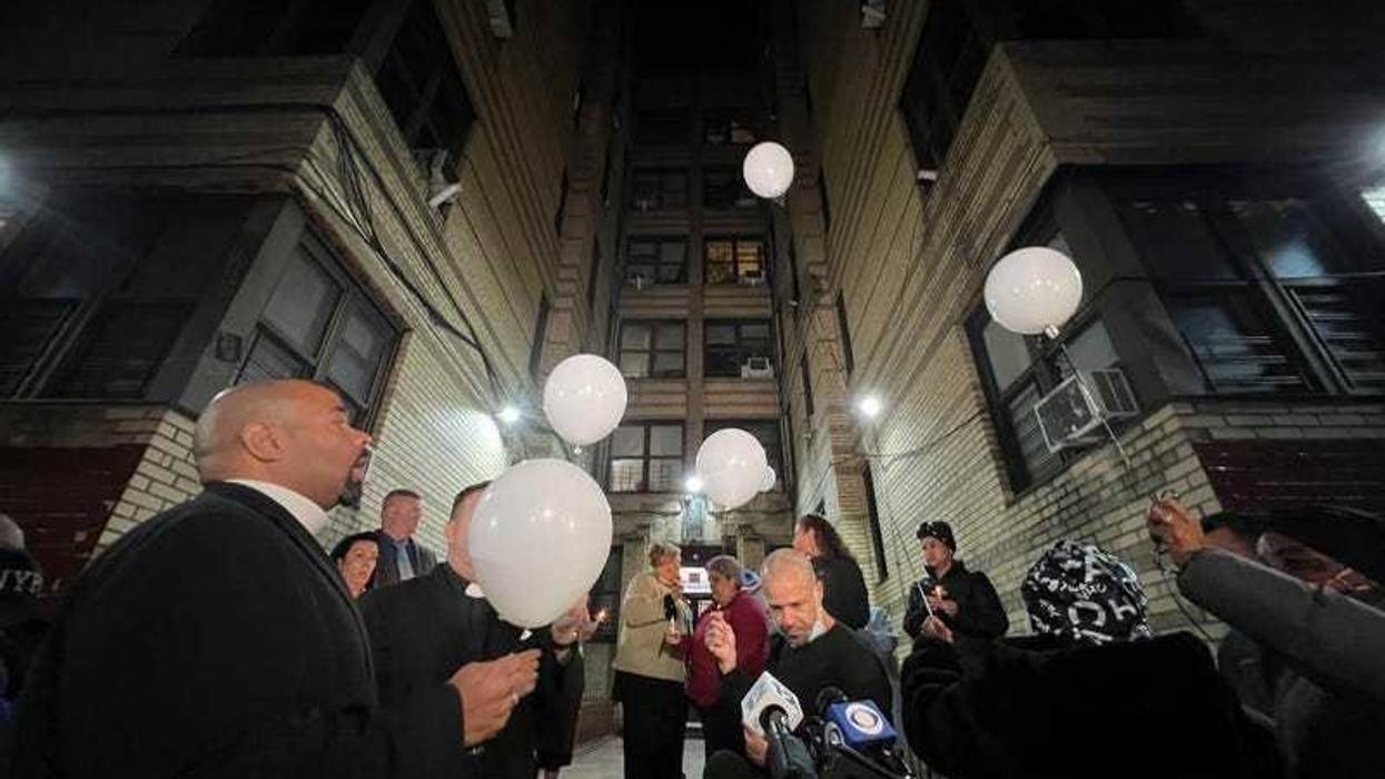 Vigil attendees in November 2022 release balloons in honor of the two twin boys who were found dead in a Bronx building's back alley.