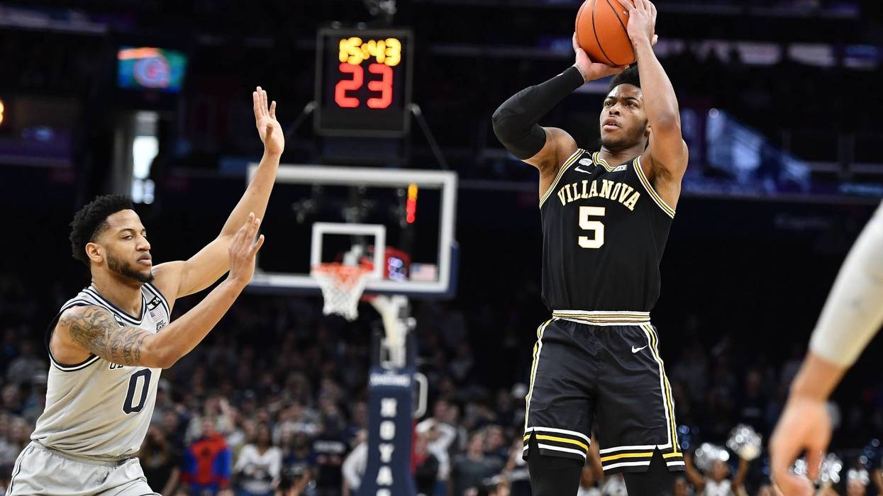 Villanova Wildcats guard Justin Moore (5) shoots as Georgetown Hoyas guard Jahvon Blair (0) looks on during the first half at Capital One Arena.