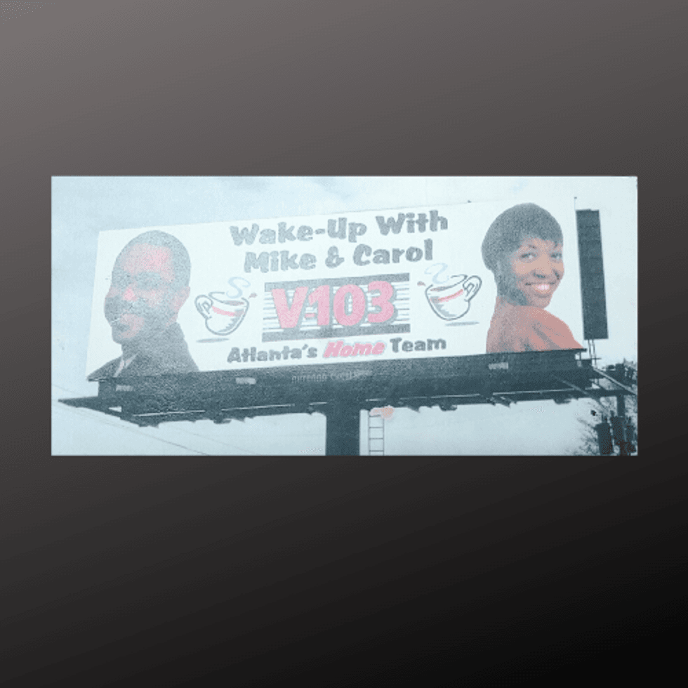 Vintage billboard sign of Mike & Carol in the Mornings on V-103 in the early 90