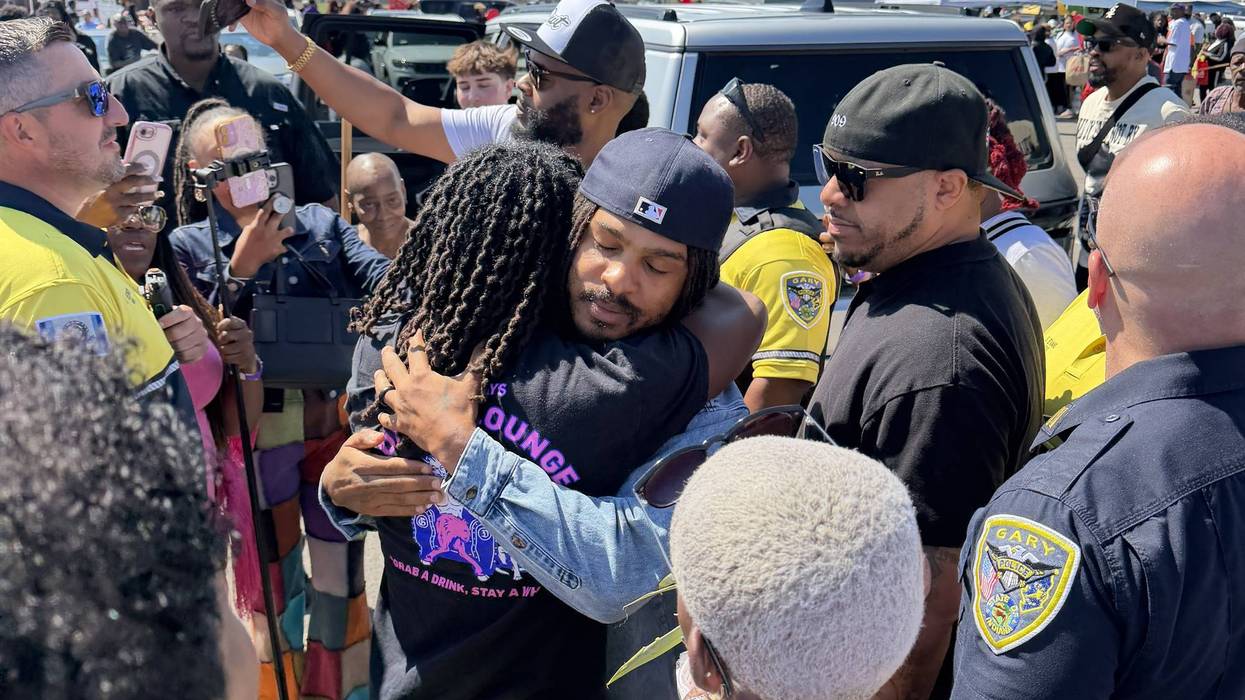 Viral food reviewer and influencer Keith Lee (center) greets fans during a relief event for people affected by storms in Gary.