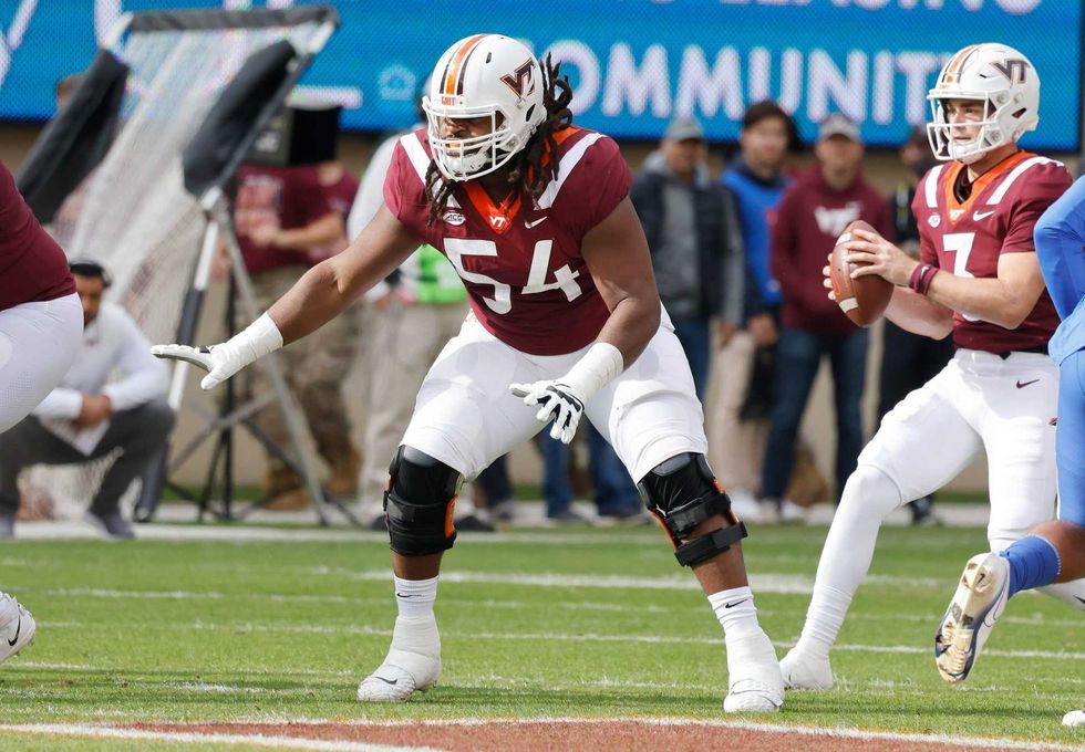 Virginia Tech Hokies offensive lineman Lecitus Smith (54) guards the line for quarterback Braxton Burmeister (3) during the first quarter against the Pittsburgh Panthers at Lane Stadium.
