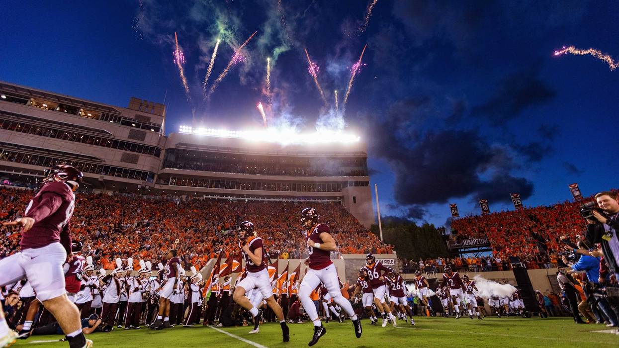Virginia Tech players run onto the field prior to their 2022 matchup with West Virginia.