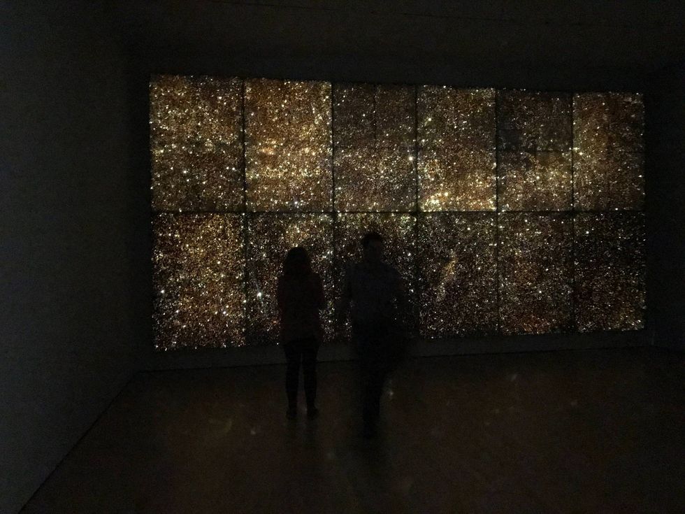 Visitors appreciate new works on view.