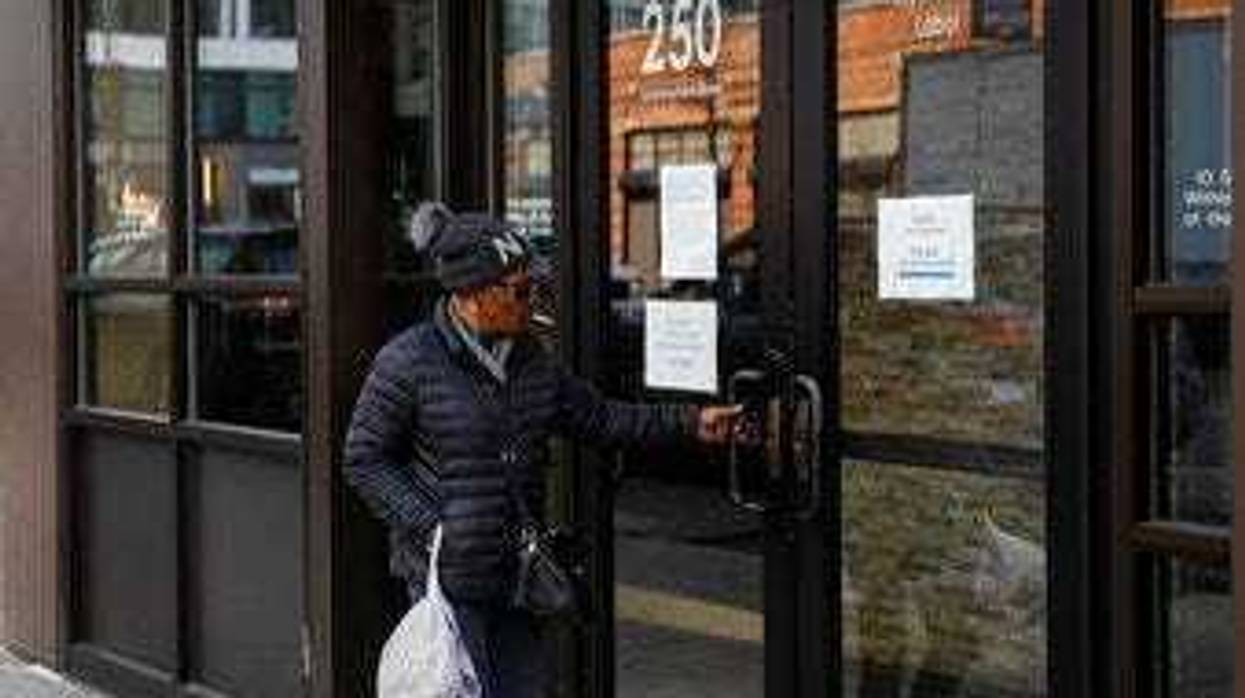 Visitors are unable to gain access to the Department of Labor due to closures over coronavirus concerns, Wednesday, March 18, 2020, in New York. (AP Photo/John Minchillo)