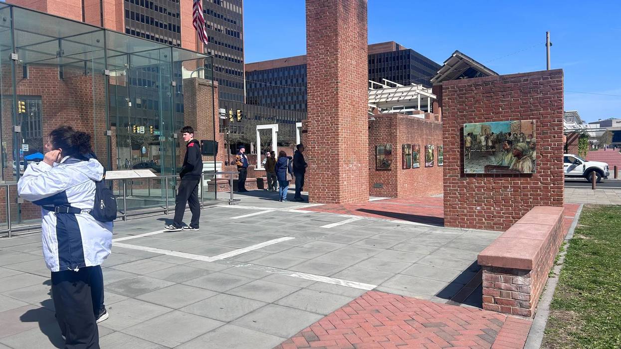 visitors at the President's House look at the exhibit