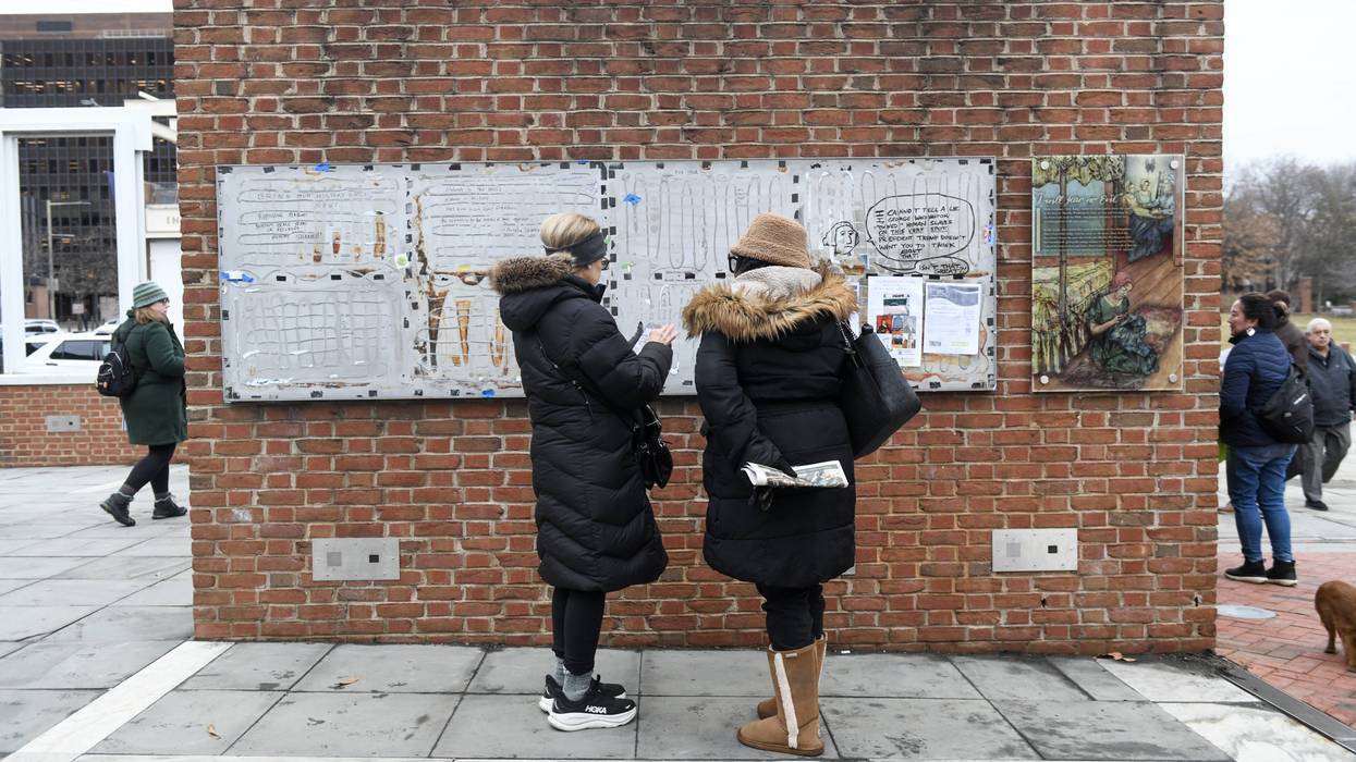 Visitors inspect messages left on the missing panels of the 'Freedom and Slavery in the Making of a New Nation' exhibit at the President's house on February 19, 2026 in Philadelphia, Pennsylvania.