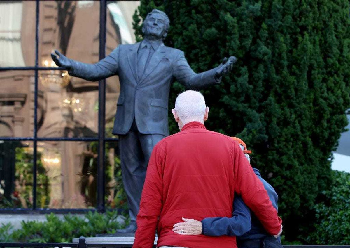 Visitors look at a statue of Tony Bennett at the Fairmont Hotel on July 21, 2023 in San Francisco, California. Legendary crooner Tony Bennett died this morning at the age of 96, two weeks short of his birthday. Bennett was diagnosed with Alzheimer’s disease in 2016. The singer was best known for his song "I left my heart in San Francisco" and was the recipient of 19 Grammy awards. (Photo by Justin Sullivan/Getty Images)