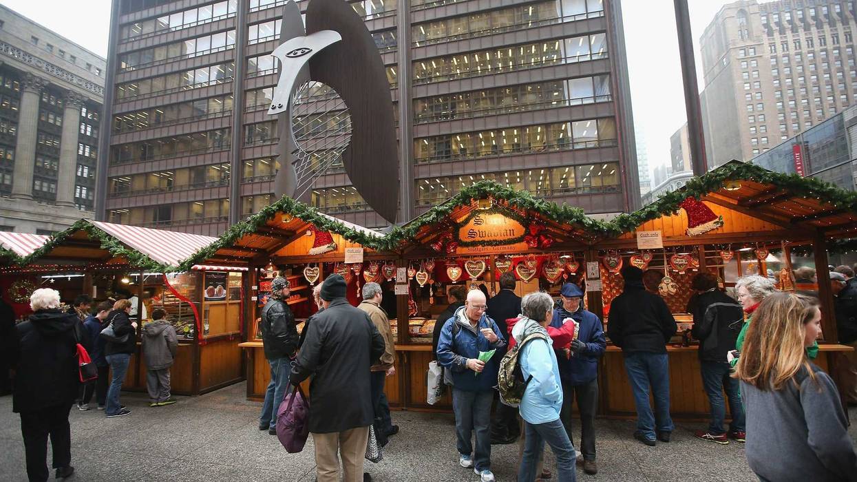 Visitors shop at Christkindlmarket Chicago on December 4, 2013 in Chicago, Illinois. Christkindlmarket Chicago is a German-themed outdoor market open during the Christmas shopping season in Daley Plaza in the Chicago Loop. Vendors sell gifts, crafts, ornaments and traditional German food at the market.