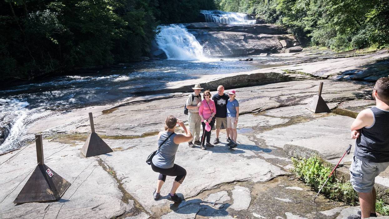 Visitors to Triple Falls in DuPont State Recreational Forest, view the falls from the roped-in viewing area at the base of the falls Thursday, July 26, 2018. 636685587642086186-DuPontFalls-MB2-07262018.jpg