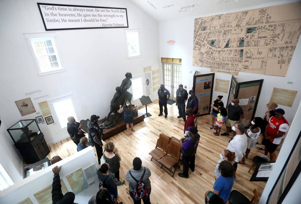 Visitors tour the Harriet Tubman Museum of New Jersey.