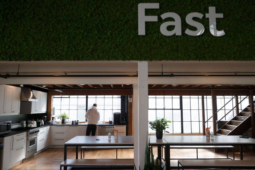 Vlad Lapich, with tech startup company Fast, makes coffee in the kitchen on the first day back in the office on March 24, 2021 in San Francisco, California.