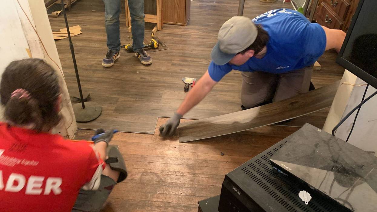 Volunteers putting a floor into Robert Shell’s house in Strawberry Mansion