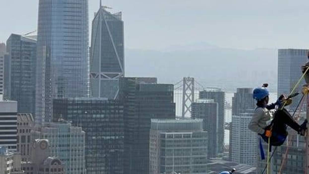 Volunteers rappel down the side of a San Francisco hotel.