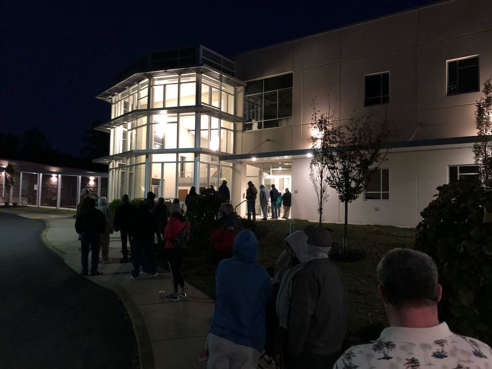 Voters wait outside a Wade Hampton precinct before sunrise