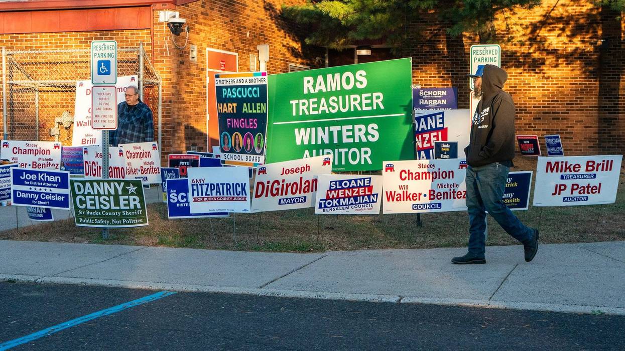 Voters walk past the election lawn signs at the Belmont Hills Elementary School polling location in Bensalem on Nov. 4, 2025.