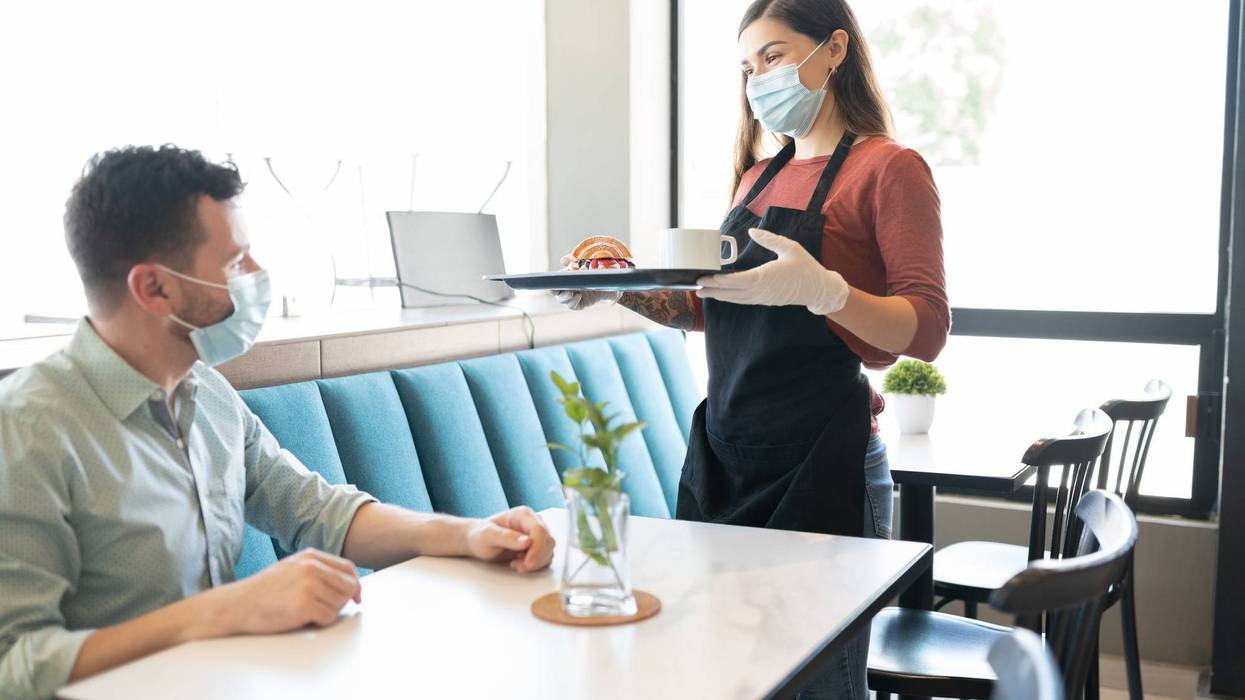 Waitress Serving Order To Customer In Cafe