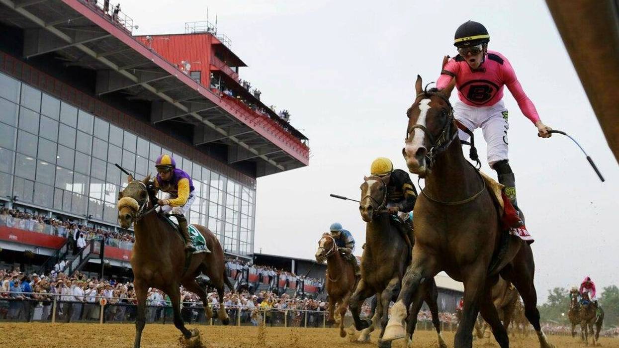 War of Will, ridden by Tyler Gaffalione, right, crosses the finish line first to win the Preakness Stakes horse race at Pimlico Race Course.