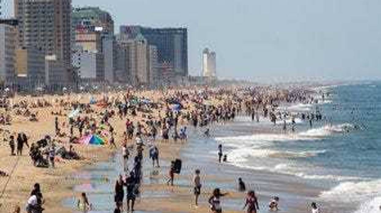 Warm weather draws crowds to the oceanfront, Saturday, May 16, 2020 in Virginia Beach, Va. (Kaitlin McKeown/The Daily Press via AP)