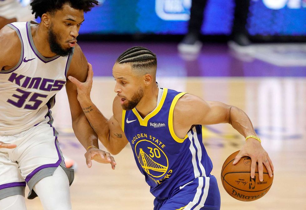 Warriors guard Stephen Curry challenges Kings defender Marvin Bagley