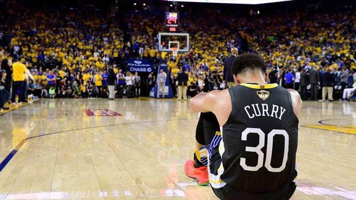 Warriors guard Stephen Curry drives to the basket against Cavaliers center Kevin Love during the fourth quarter in Game 2 of the NBA Finals on June 3, 2018, at Oracle Arena in Oakland, California.