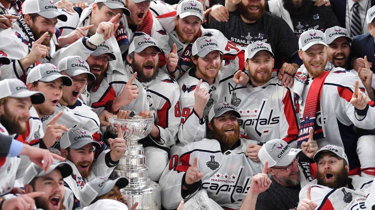 Washington Capitals players pose for a team photo with the Stanley Cup
